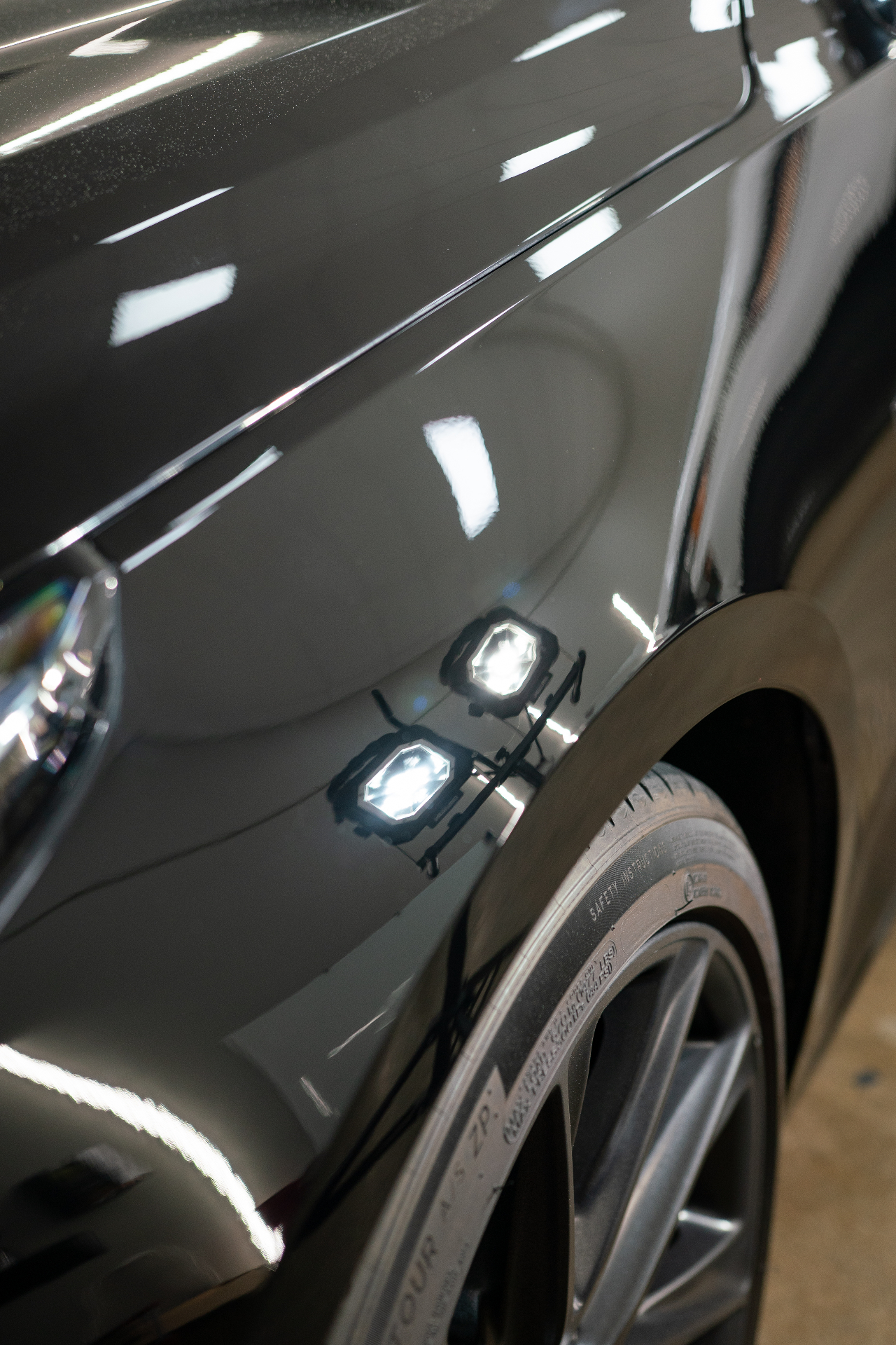 Glossy reflective paint on a Cadillac fender after graphene coating