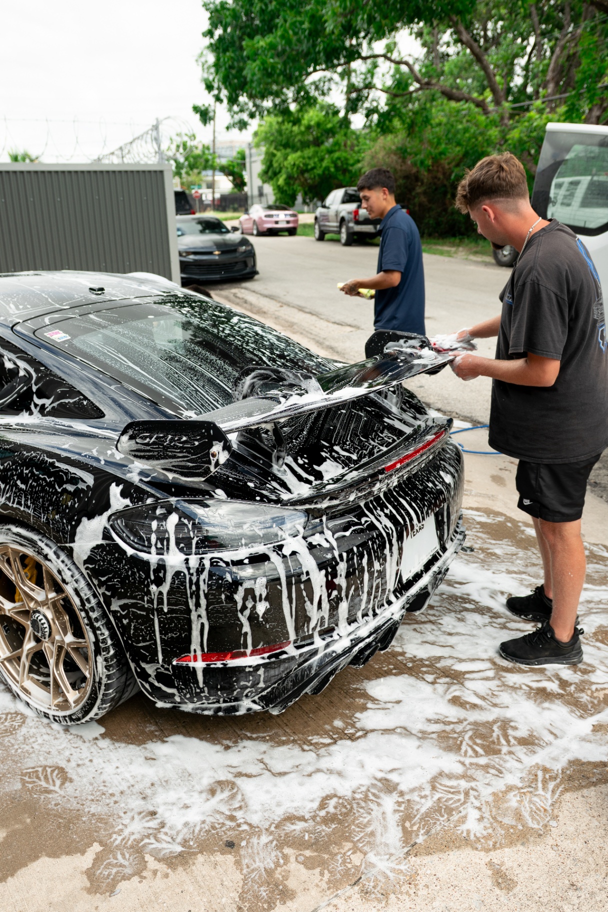 NTX Auto Care team hand washing a Porsche GT4
